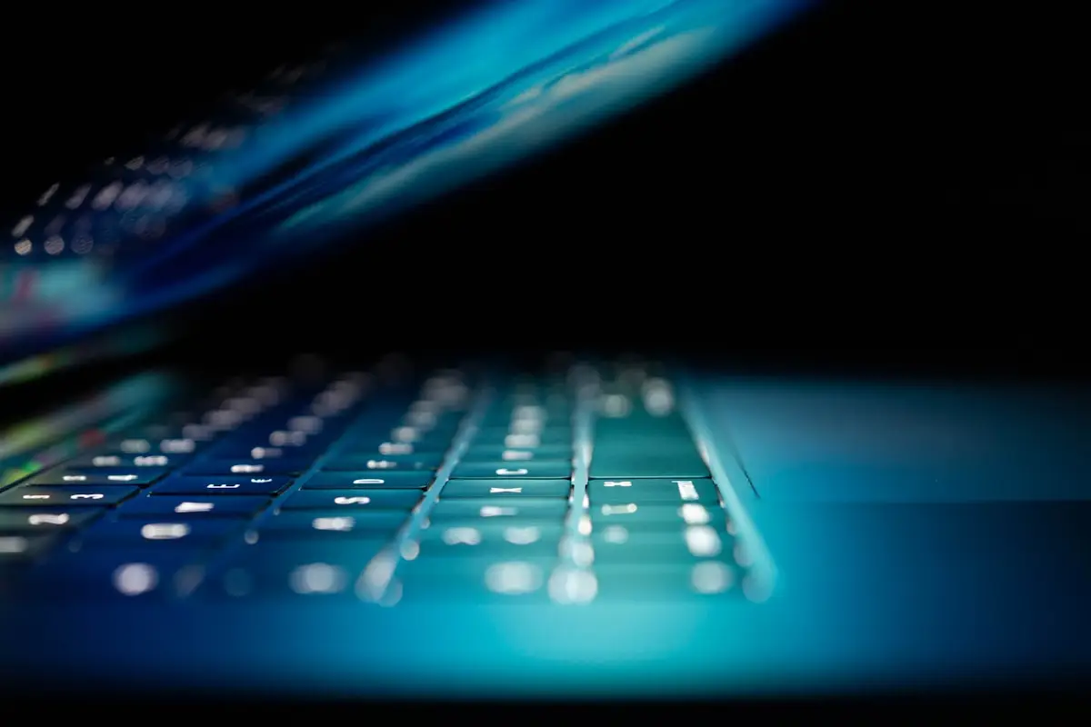 Blue illuminated computer keyboard representing AI infrastructure